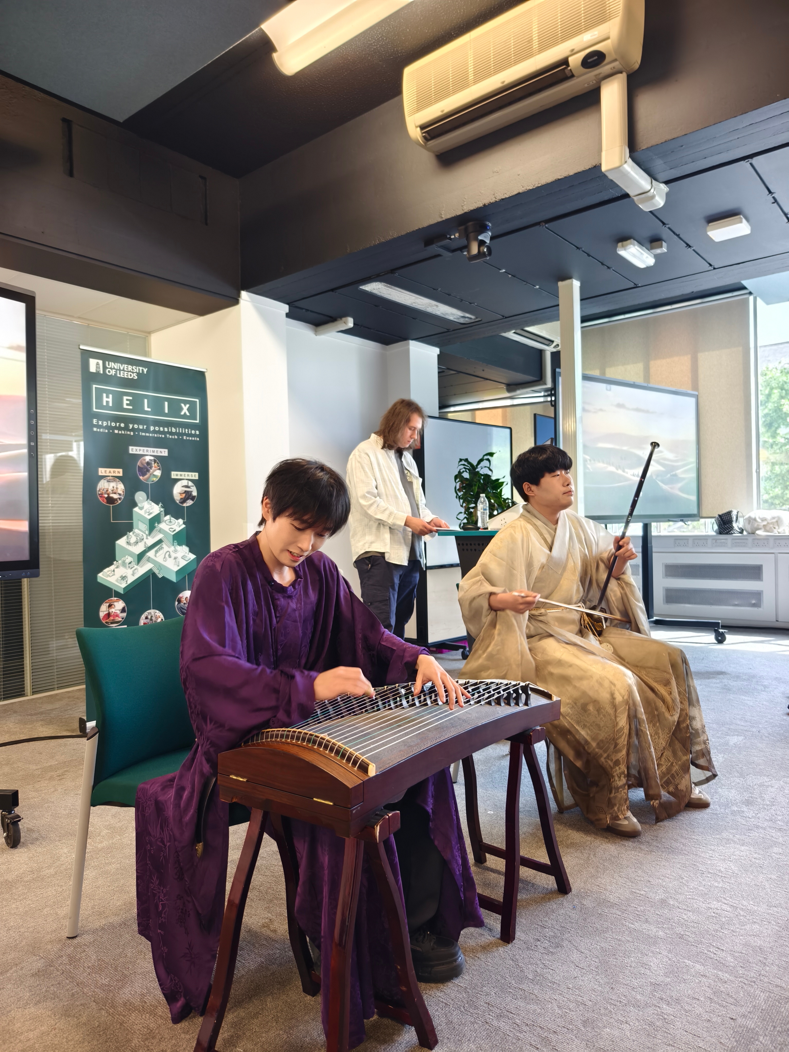 Lijun Zhang on guzheng with a fellow musician on erhu, performing for Sonic Belonging