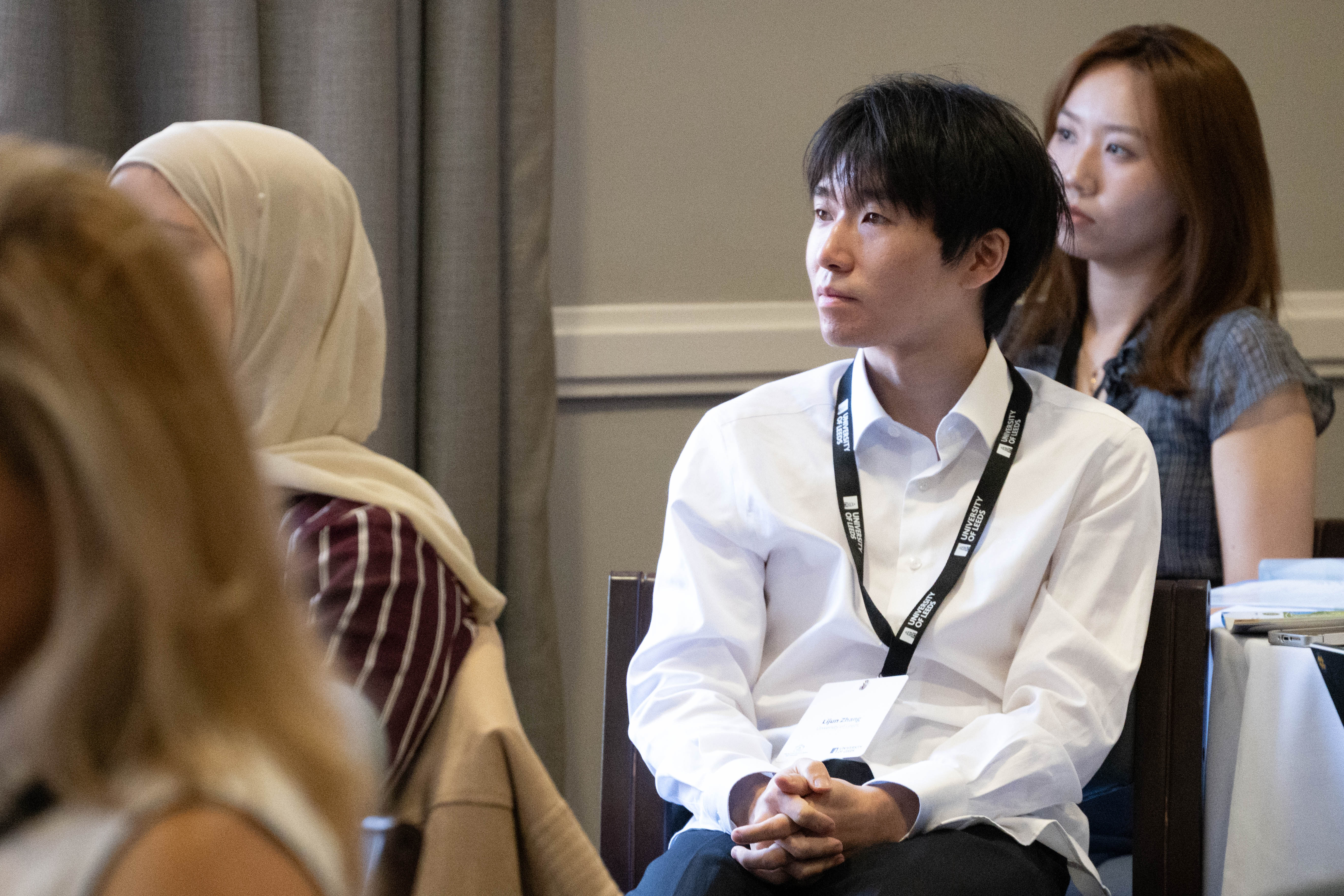 Lijun Zhang and Xiaoxuan Qin listening during the talks