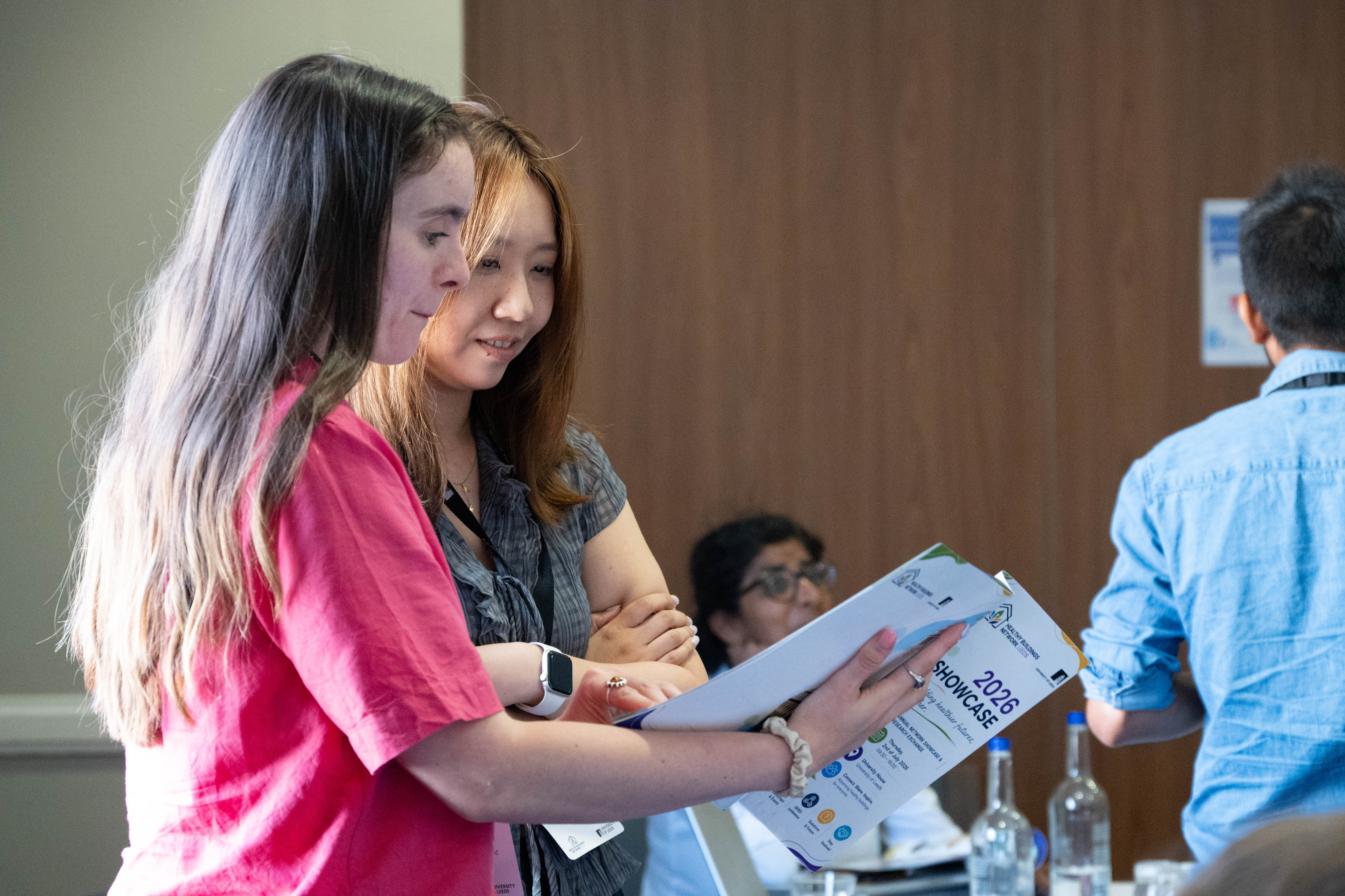 Attendees reading the HBN Showcase 2026 booklet