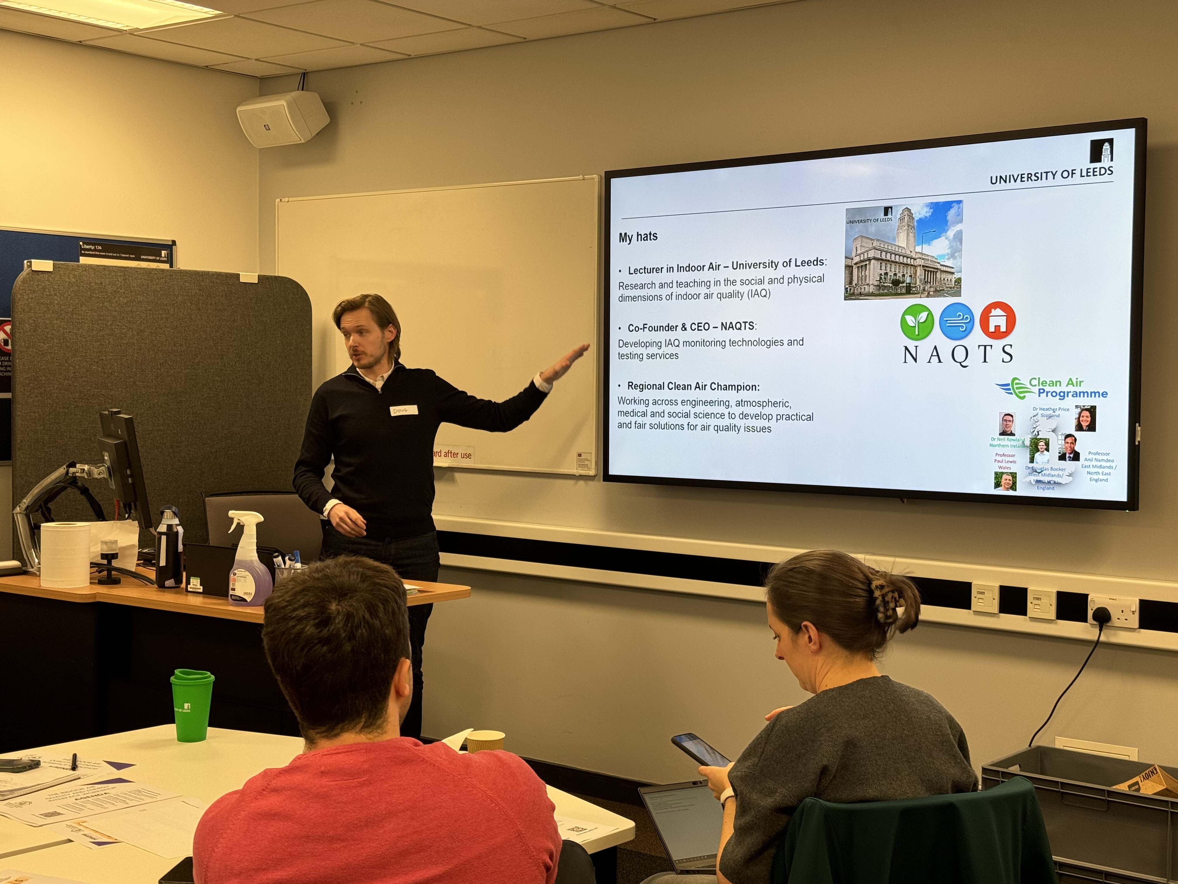 Dr Doug Booker presenting his 'My Hats' slide — Lecturer in Indoor Air, Co-Founder of NAQTS, Regional Clean Air Champion