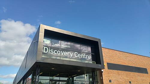 Family exploring domestic objects at Leeds Discovery Centre